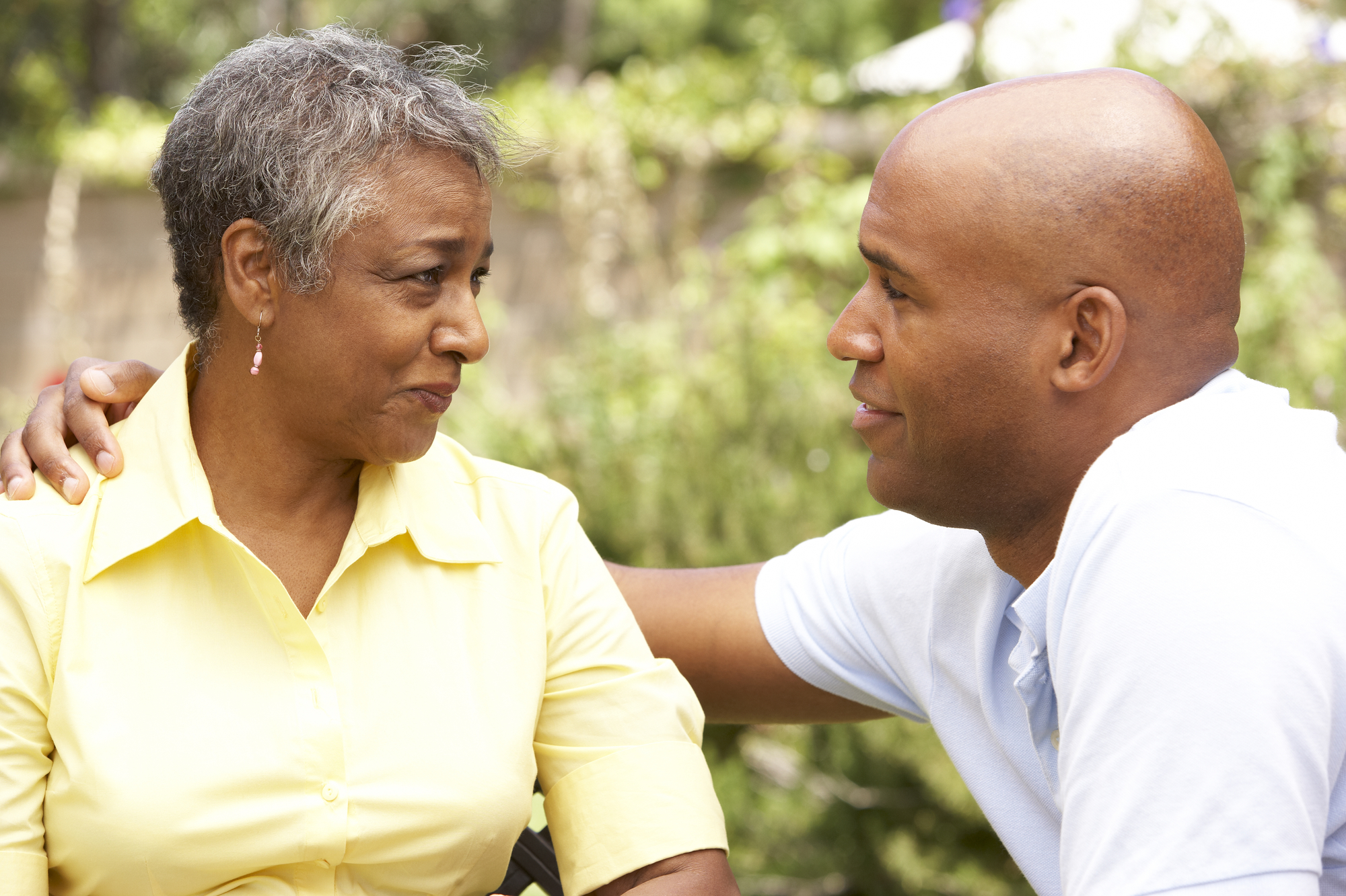 Senior Woman Being Consoled By Adult Son